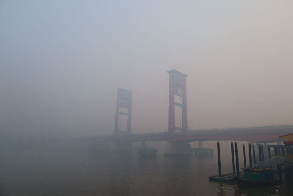 Jembatan Ampera yang tampak samar akibat kabut asap di Kota Palembang, Sumatera Selatan